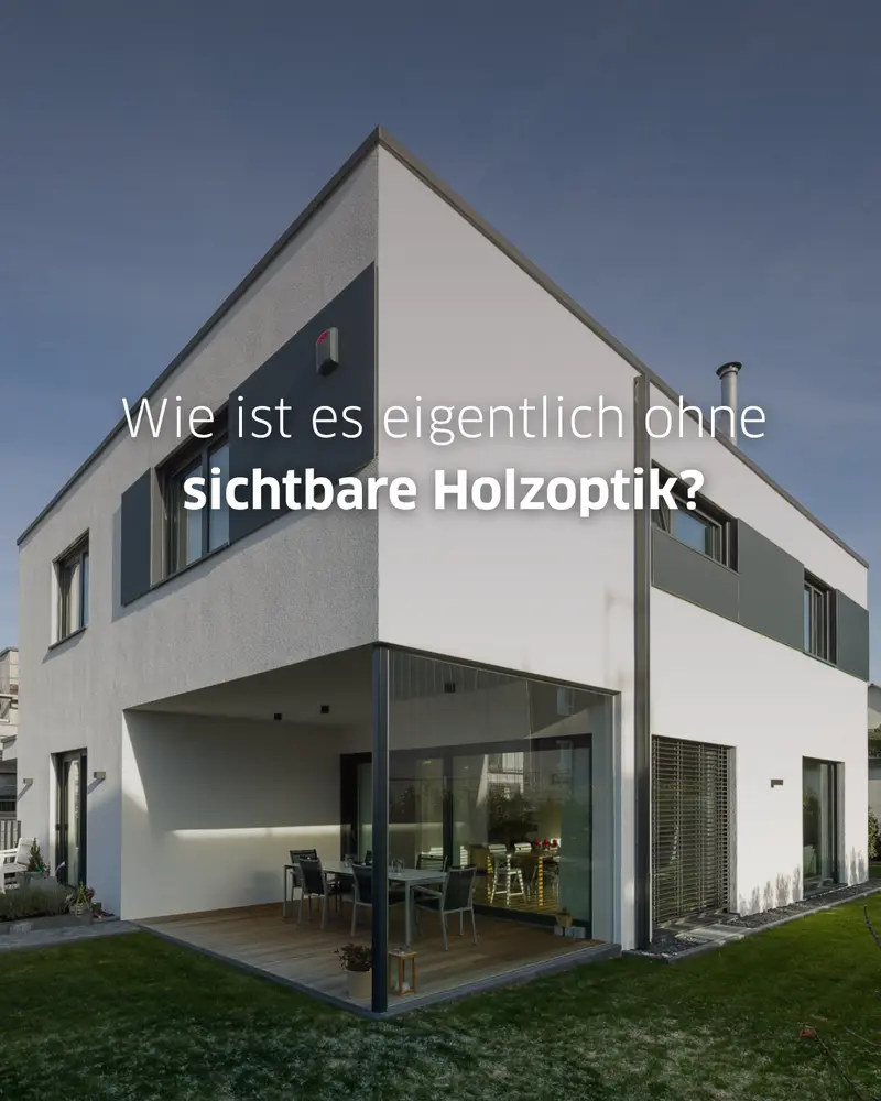 Modernes zweigeschossiges Holzhaus mit weißer Putzfassade, klarer kubischer Architektur, großformatigen Fensterflächen und überdachter Terrasse. Von außen ist die Holzbauweise nicht sichtbar.