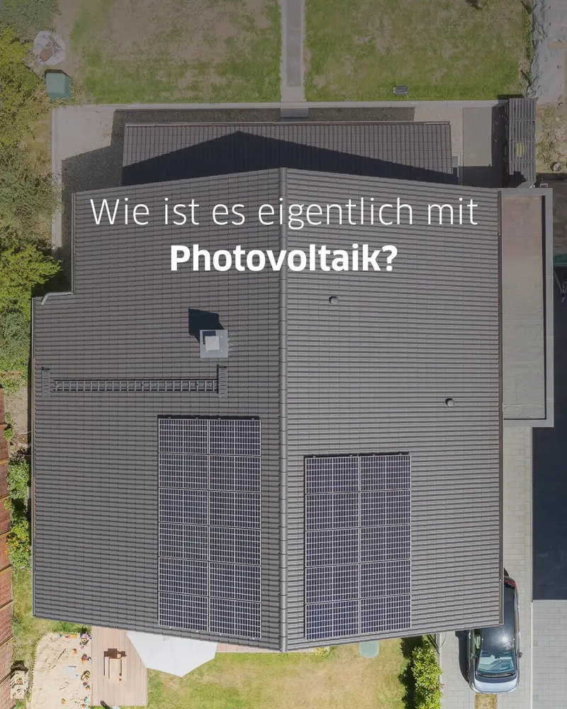 Draufsicht auf ein Wohnhaus mit zwei großen Photovoltaikflächen auf dem grauen Ziegeldach.